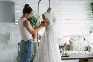 Tailor working on a white dress