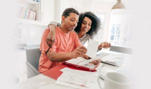 Woman and man doing finances smiling together