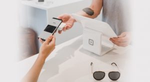 Woman making a touchless payment using Google Pay