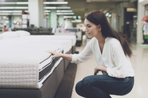 Woman looking at mattress in a store