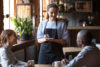 Young woman as a waitress in a coffee shop