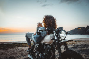 Woman reclining on motorcycle