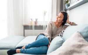 Woman sitting on couch smiling