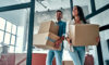 Woman and man moving in with boxes