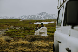 Woman and man in the wilderness of Iceland with 4x4 Jeep