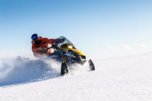 Snowmobile kicking up snow
