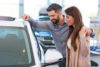 Woman and man looking at car