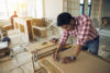 Carpenter drawing lines on wood at a construction site