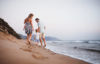 Woman and man on the beach with their child