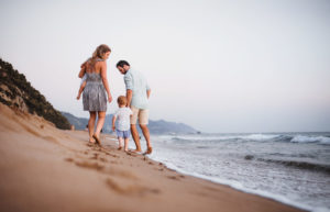 Woman and man at beach with two children