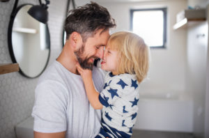 Man holding child laughing together