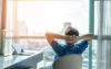 Man leaning back in his chair looking out of a window