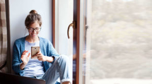 Woman smiling looking at smart phone