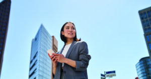 Business woman in the city on phone
