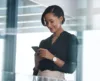 Business woman smiling looking at her phone