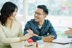 Man and Woman smiling at each other looking over documents.