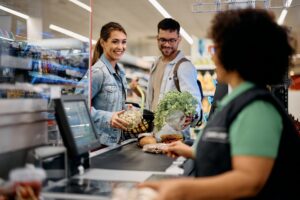 couple checking out at grocery store
